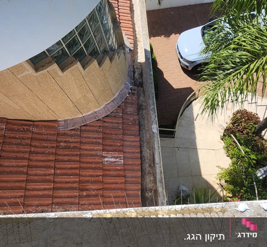 תמונה של גג עם רעפים ומעקה בטון